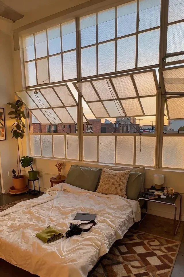 Urban loft bedroom with floor-to-ceiling windows